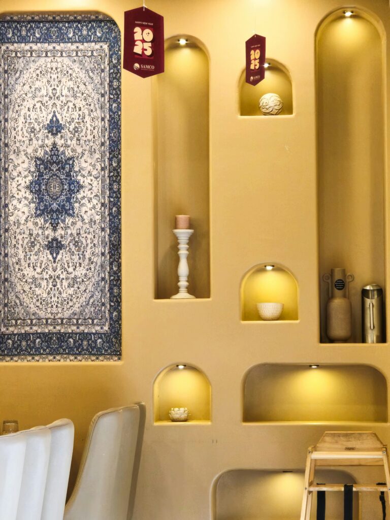 Stylish interior featuring recessed shelves and a detailed tapestry in warm lighting.