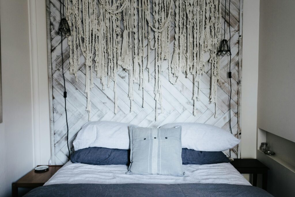 Cozy bedroom interior featuring a unique hanging decoration on a wooden headboard.