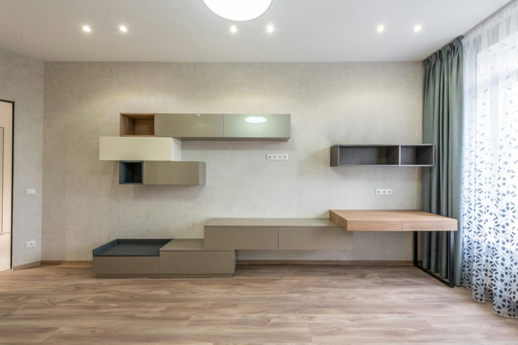 Spacious and bright modern living room with minimalist shelving and elegant decor.