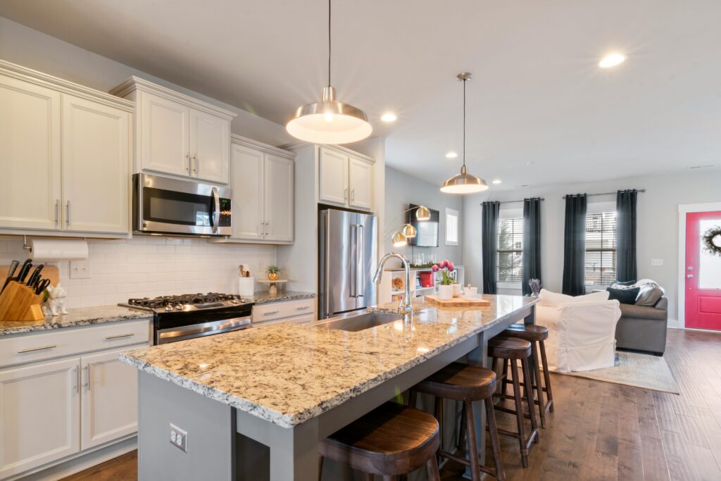 Sleek modern kitchen and cozy living room with upscale interior design.