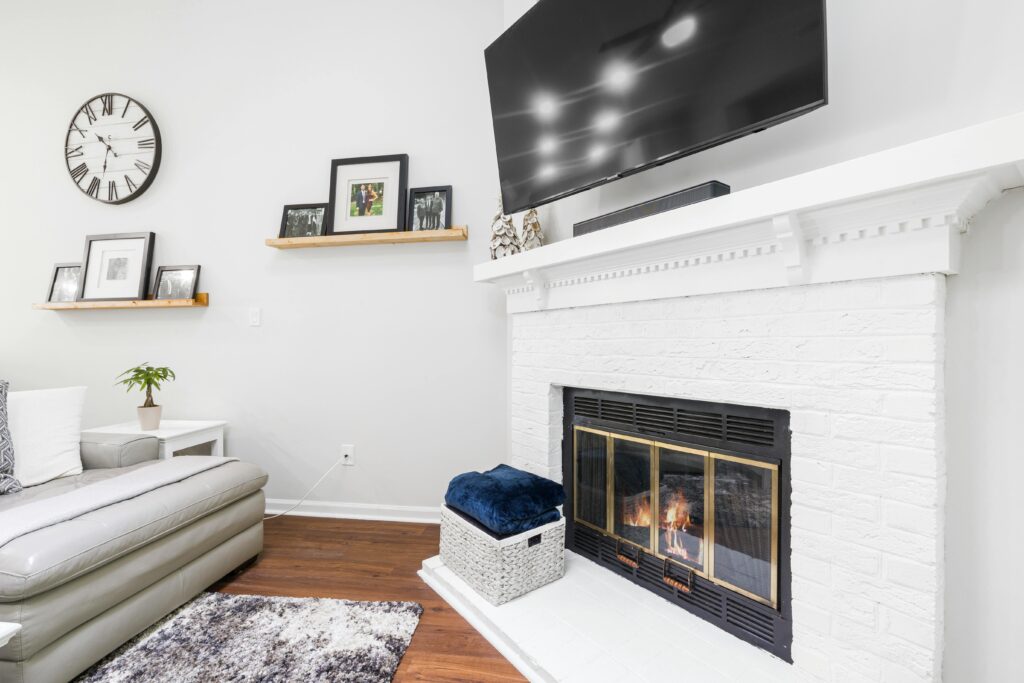 Bright living room with a modern fireplace and decor elements, perfect for comfort and style.