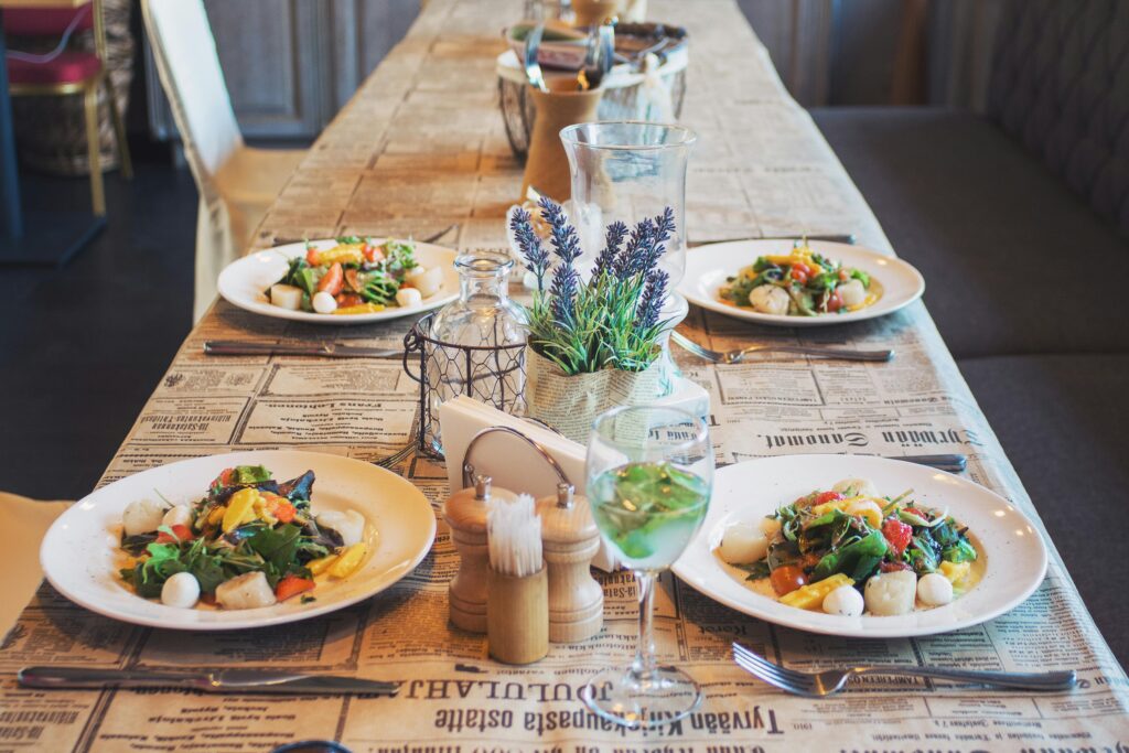 A beautifully arranged table with fresh salads, perfect for a restaurant or café setting.