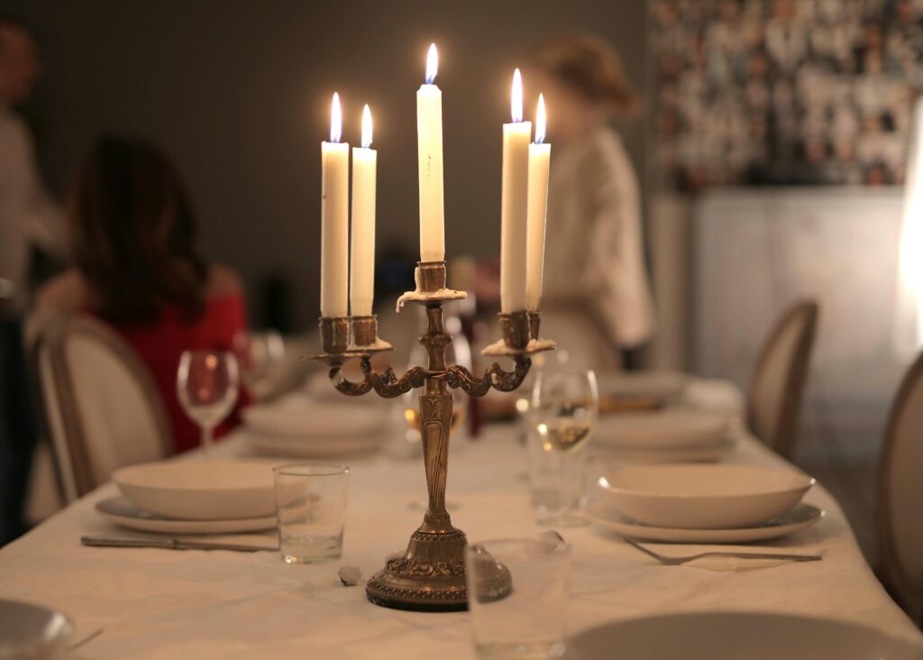 A beautifully arranged dinner table with candles creating a warm ambiance indoors.