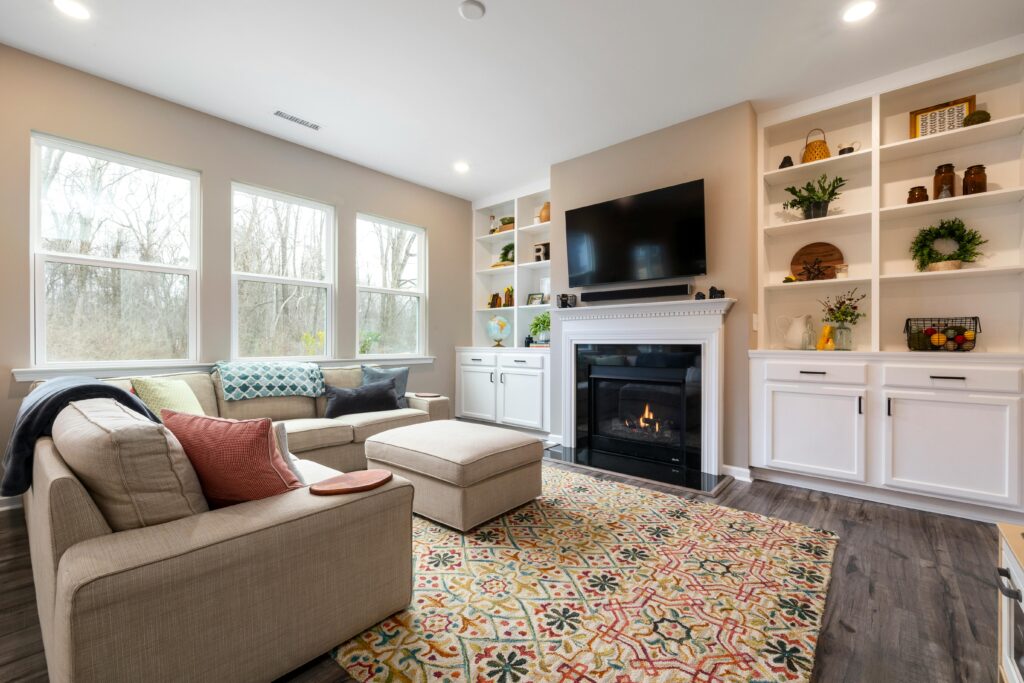 Inviting living area featuring a fireplace, modern decor, and large glass windows.