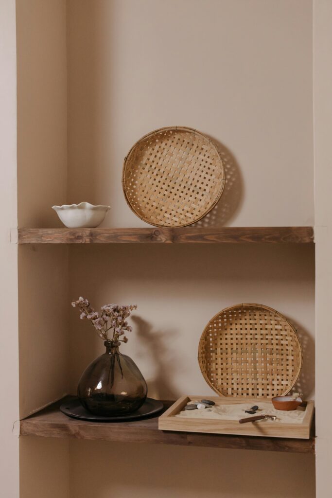 Elegant minimalist shelf featuring woven baskets and decorative items in a zen-inspired arrangement.
